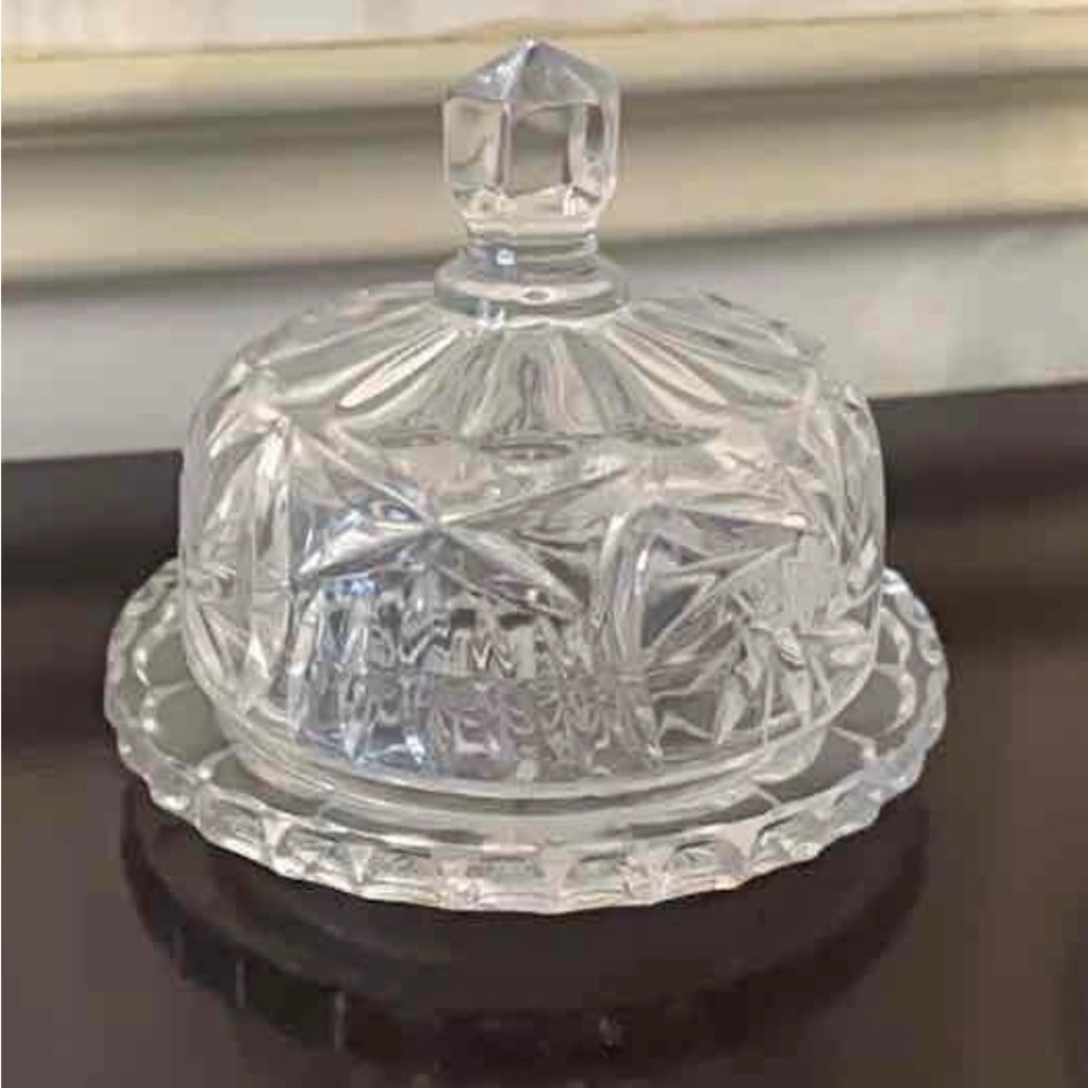 A vintage cut crystal glass butter dish with a domed lid.